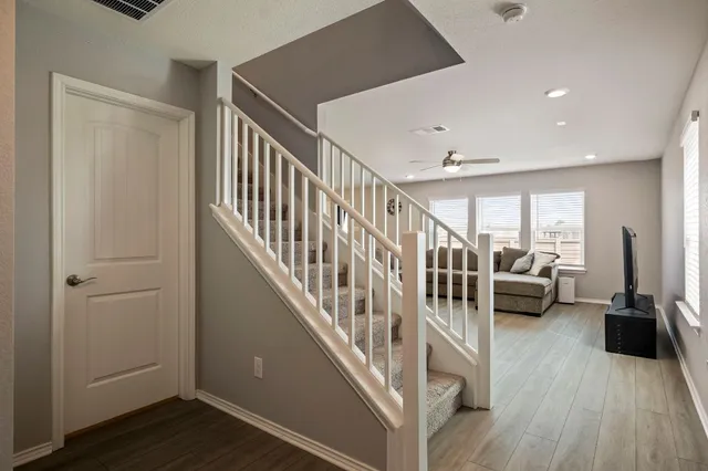 a view of front door with livingroom with furniture and stairs