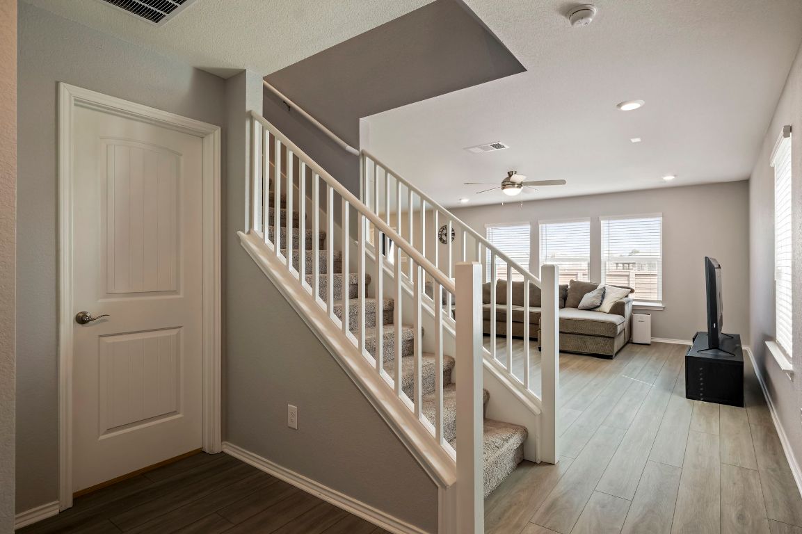 19417 James Carter Jr Street Manor, TX 78653 - Photo 18 of 37 a view of front door with livingroom with furniture and stairs