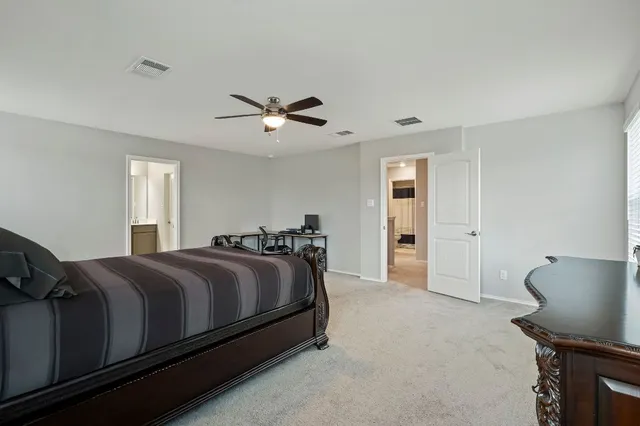 a bed room with a bed and a chair