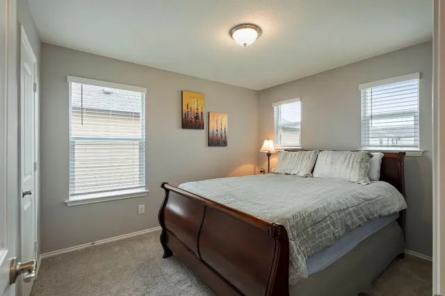 a bedroom with a bed and window