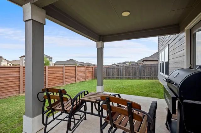a view of an outdoor space with furniture and garden
