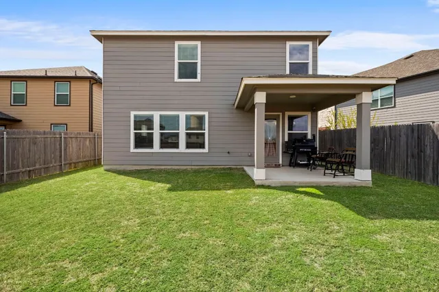 a view of a house with backyard and porch