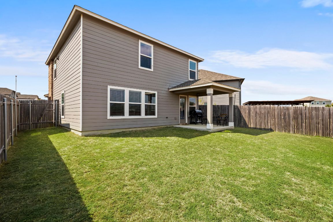 19417 James Carter Jr Street Manor, TX 78653 - Photo 31 of 37 a front view of a house with a yard