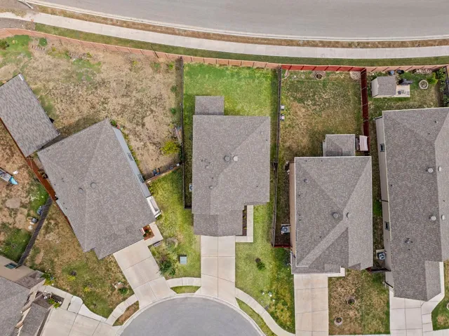 an aerial view of a house with outdoor space and a patio
