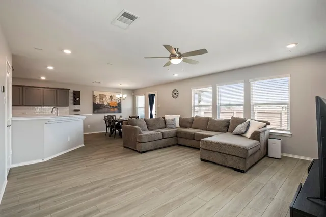 a living room with furniture and a large window