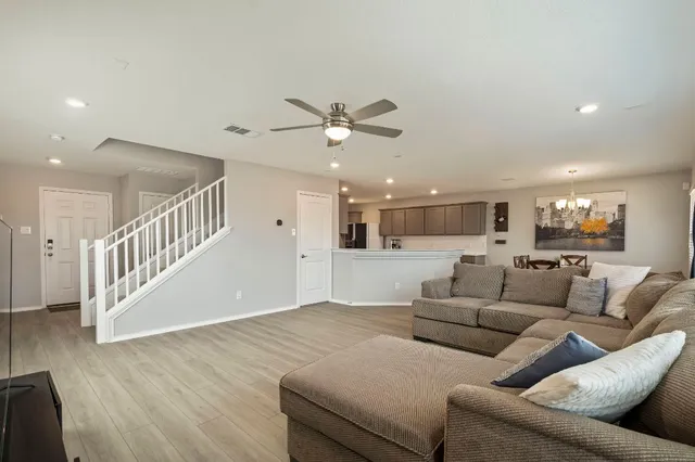 a living room with furniture and wooden floor
