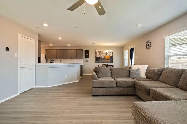 a living room with furniture and kitchen view