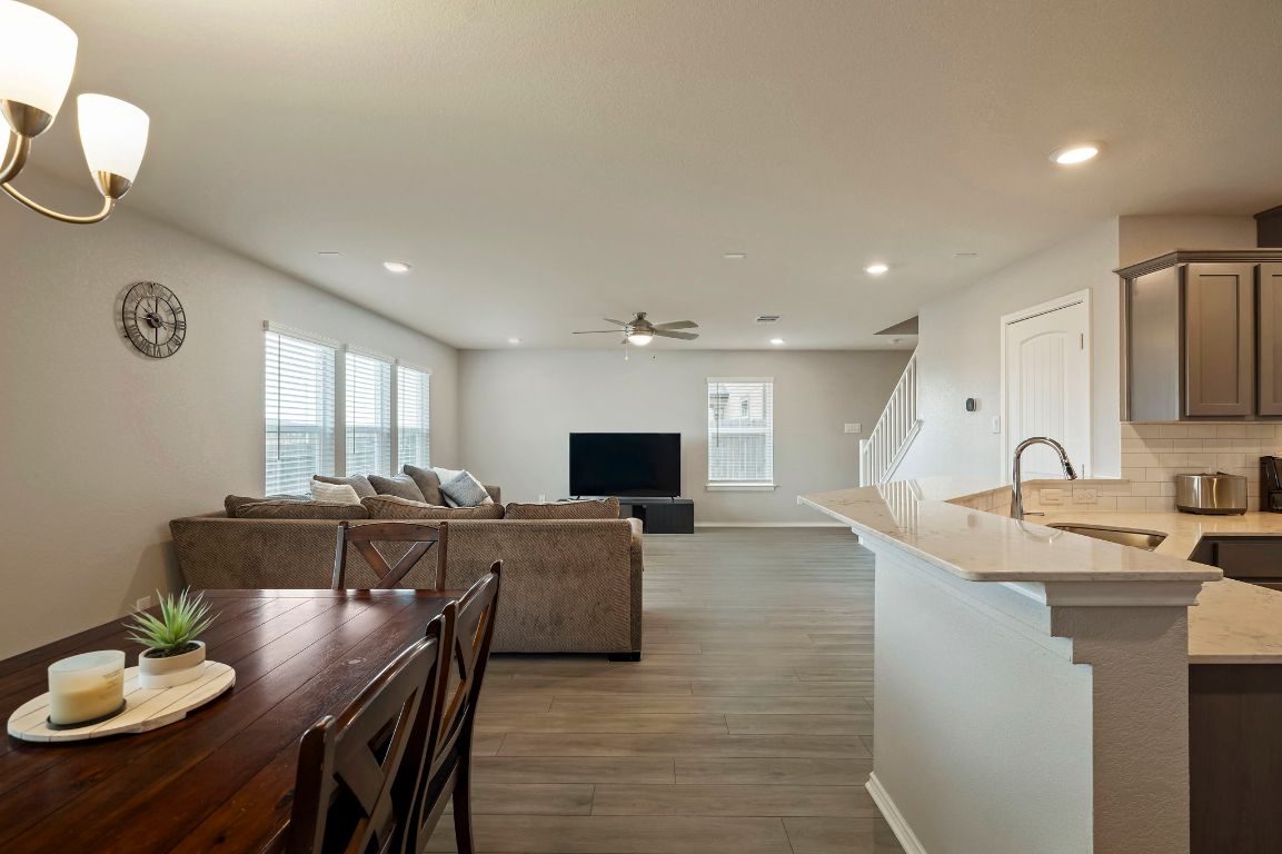 19417 James Carter Jr Street Manor, TX 78653 - Photo 10 of 37 a large kitchen with sink a microwave and dining table