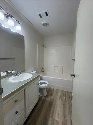 a bathroom with a double vanity sink toilet and shower
