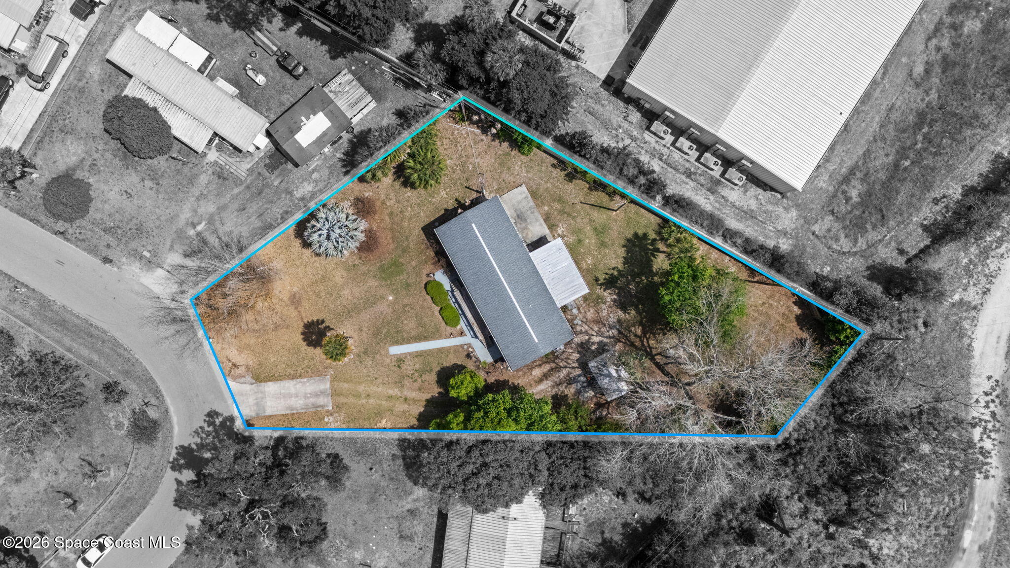 an aerial view of a house with a yard