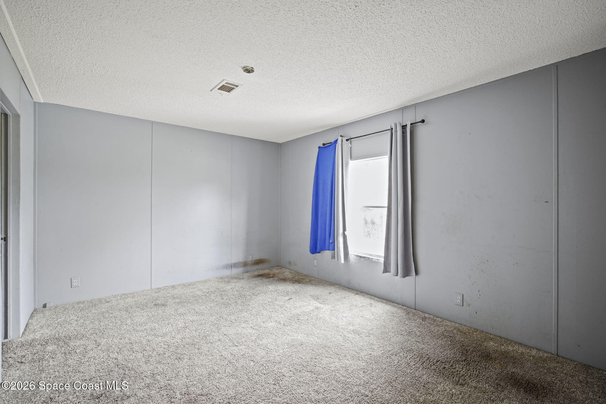3918 East Ridgewood Drive Cocoa, FL 32926 - Photo 12 of 27 a view of an empty room with window