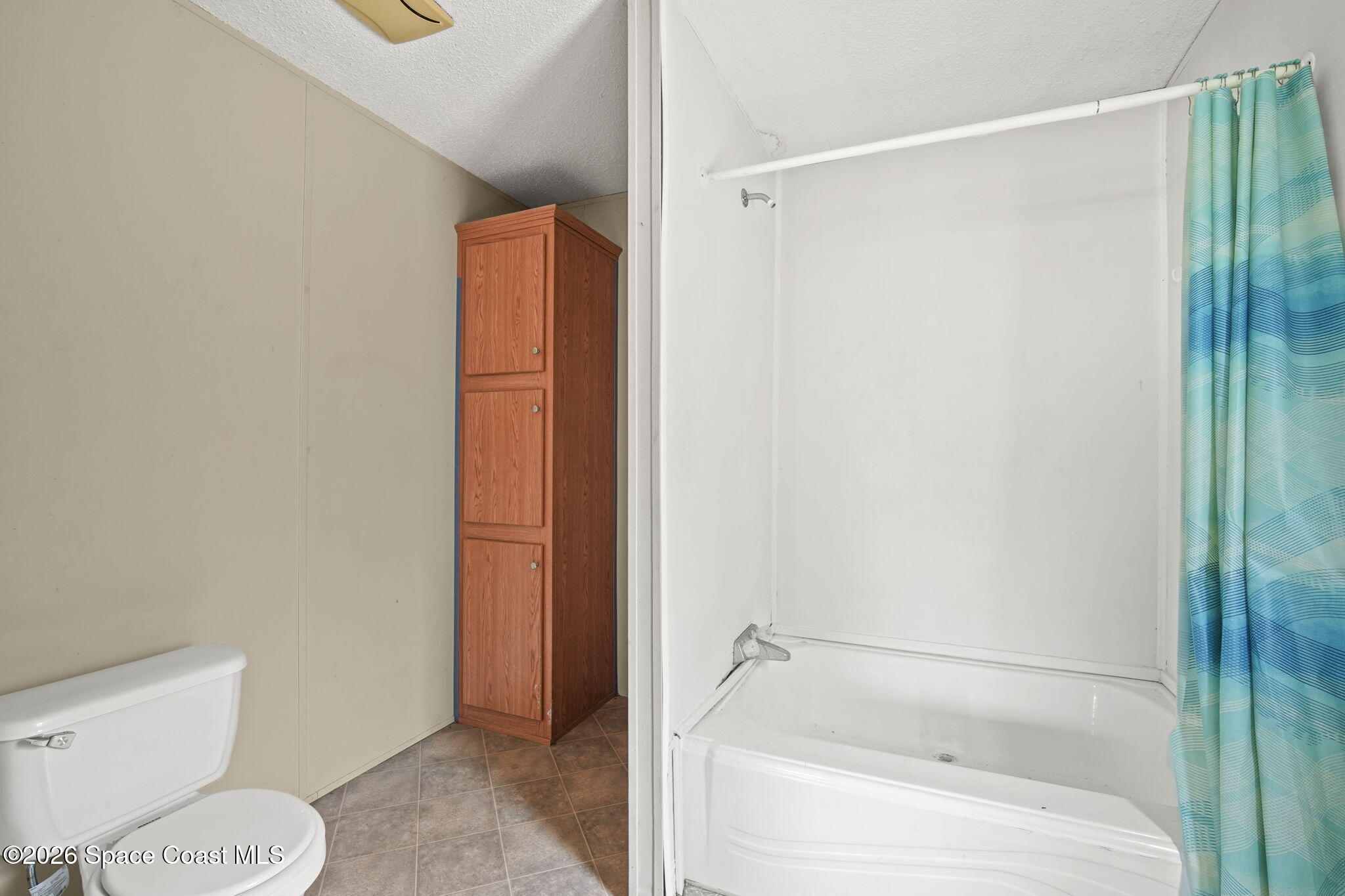 3918 East Ridgewood Drive Cocoa, FL 32926 - Photo 15 of 27 a bathroom with a shower and a toilet
