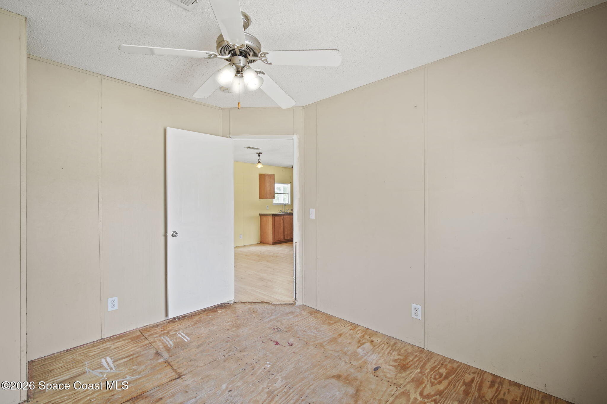 3918 East Ridgewood Drive Cocoa, FL 32926 - Photo 17 of 27 a view of a hallway with a chandelier fan