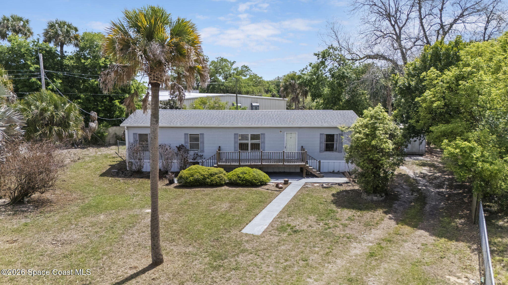 3918 East Ridgewood Drive Cocoa, FL 32926 - Photo 2 of 27 a front view of a house with garden
