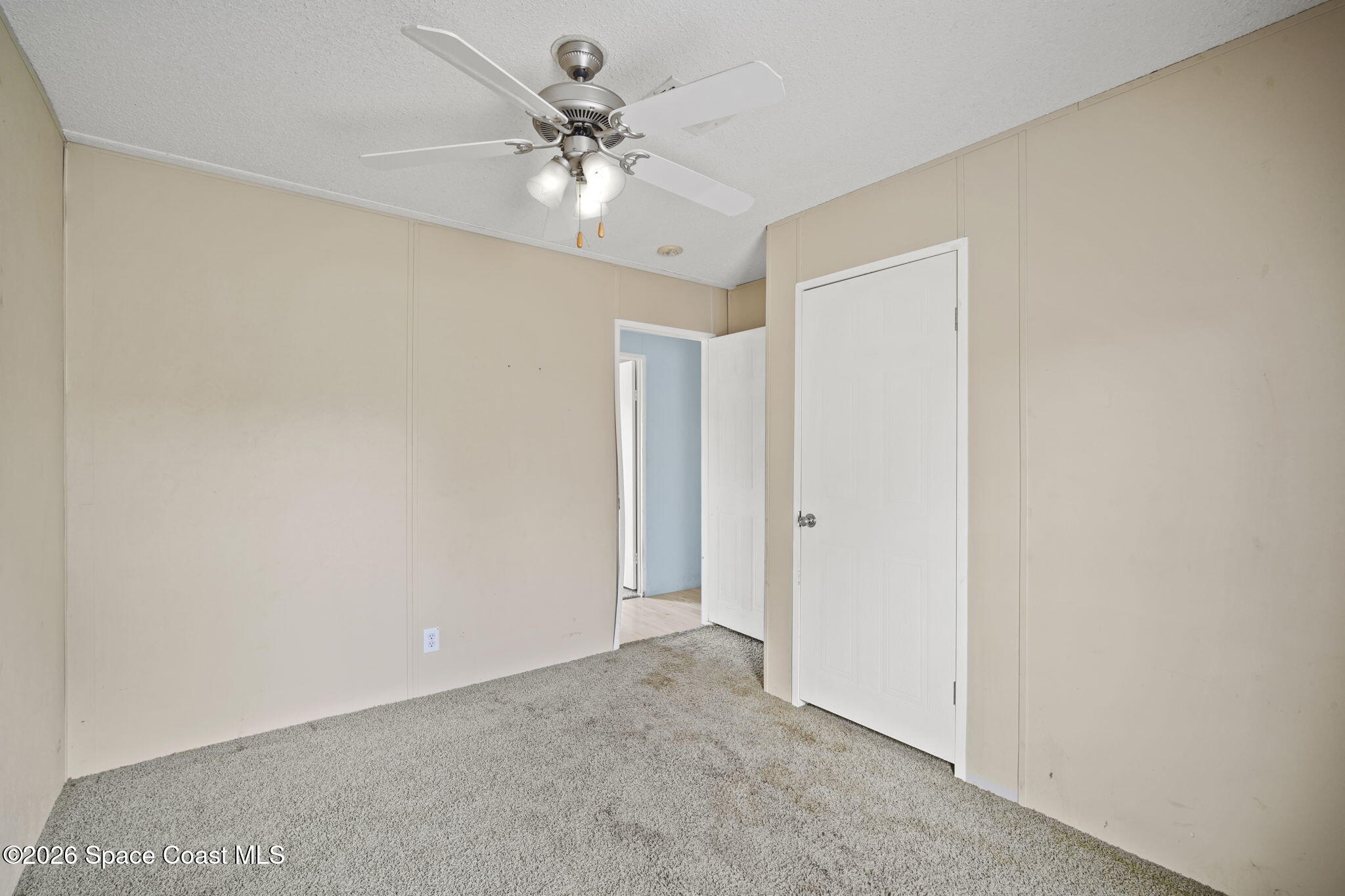 3918 East Ridgewood Drive Cocoa, FL 32926 - Photo 21 of 27 a view of an empty room with a chandelier fan