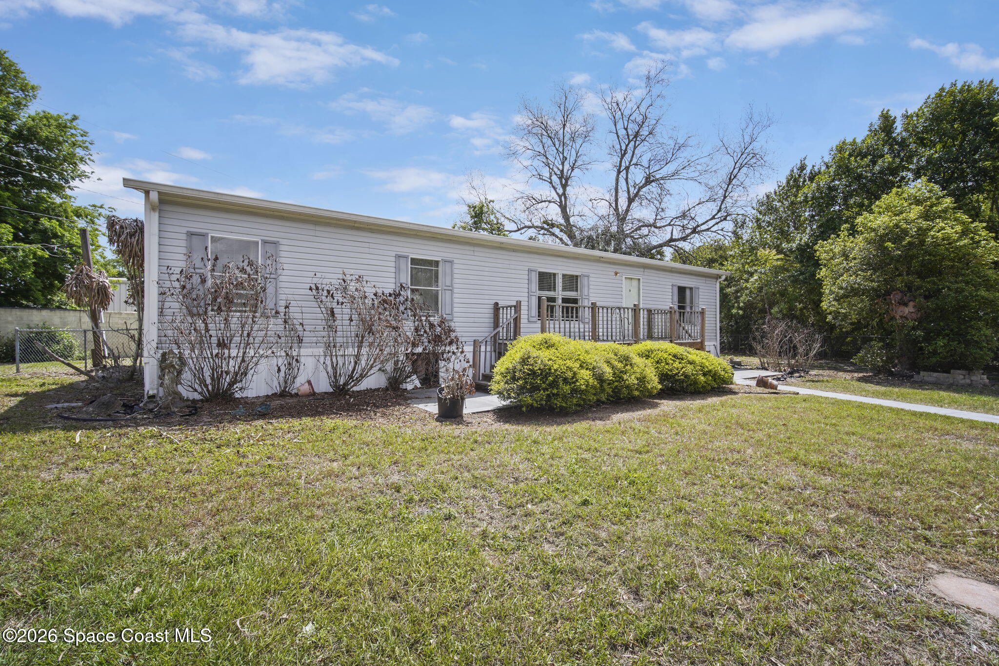 3918 East Ridgewood Drive Cocoa, FL 32926 - Photo 4 of 27 a view of a house with backyard and garden