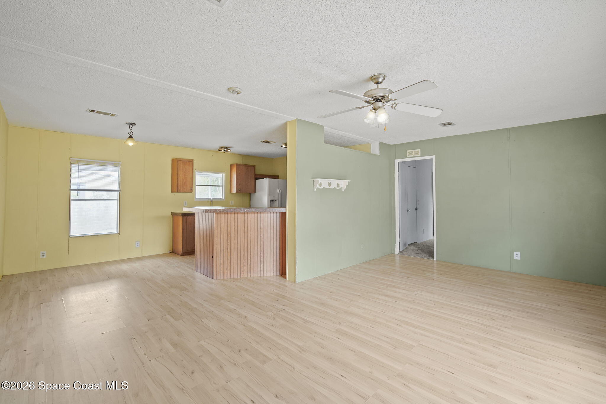 3918 East Ridgewood Drive Cocoa, FL 32926 - Photo 7 of 27 a view of a kitchen with a sink and a chandelier fan