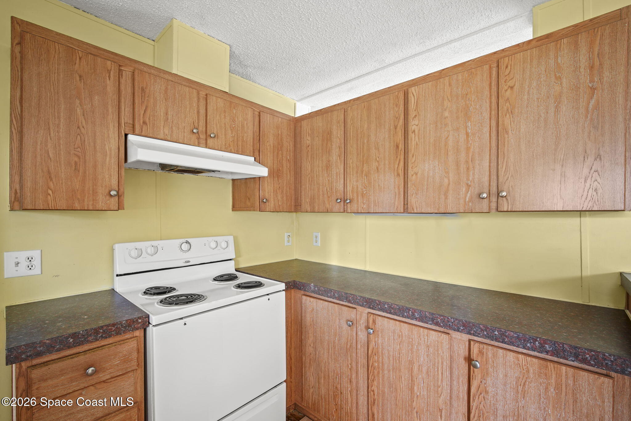3918 East Ridgewood Drive Cocoa, FL 32926 - Photo 10 of 27 a kitchen with a stove and a cabinets