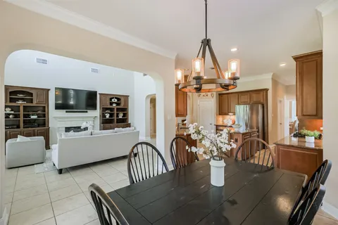 a dining room with furniture and a chandelier