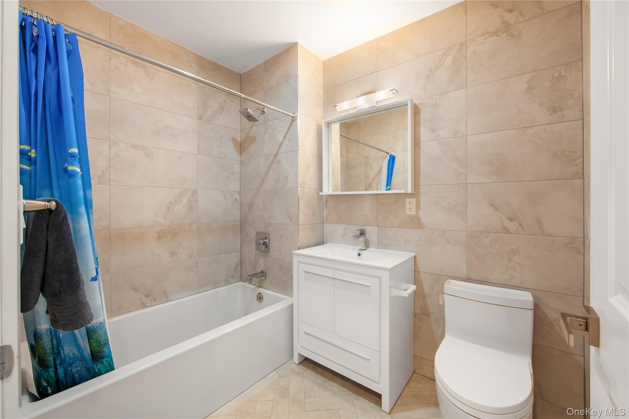 109-19 72nd Road, Unit 7B Queens, NY 11375 - Photo 11 of 17 a bathroom with a toilet sink and bathtub