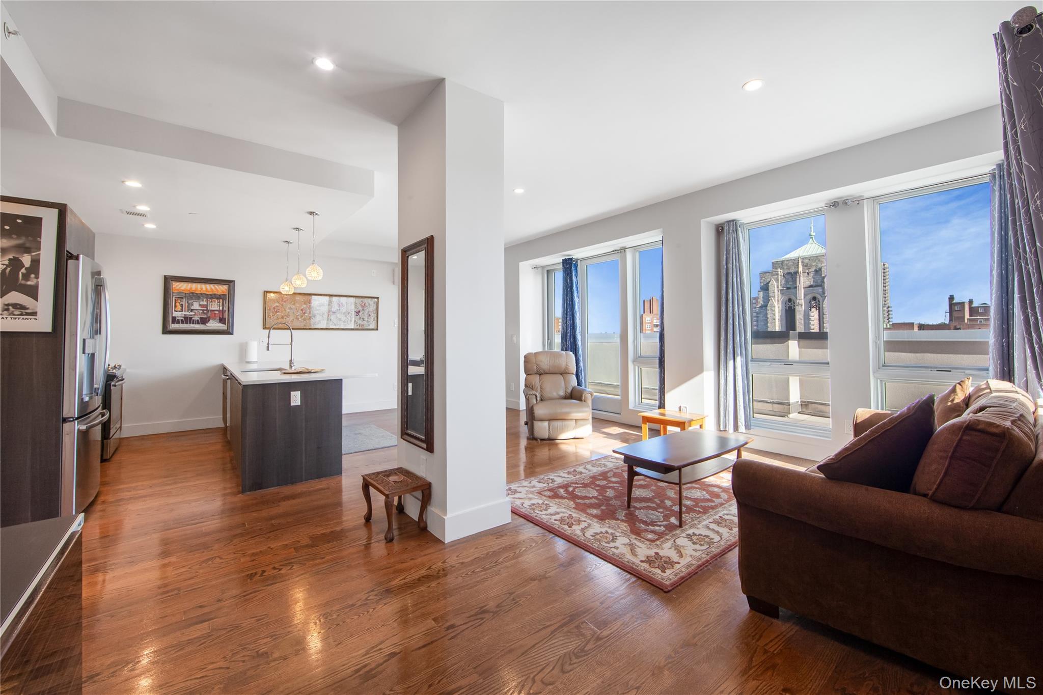109-19 72nd Road, Unit 7B Queens, NY 11375 - Photo 3 of 17 a living room with furniture and a large window