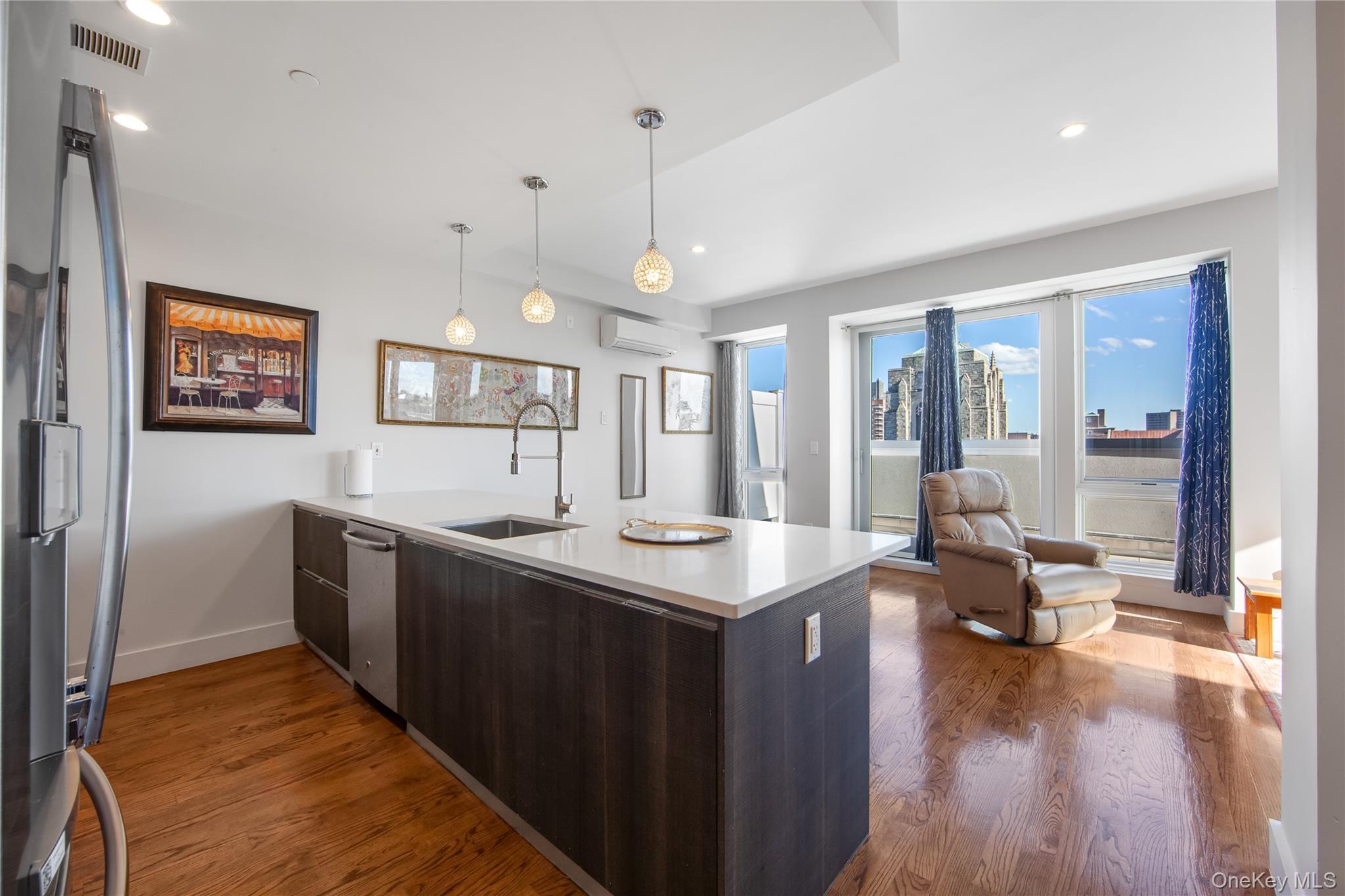 109-19 72nd Road, Unit 7B Queens, NY 11375 - Photo 6 of 17 a kitchen with stainless steel appliances granite countertop a sink and a refrigerator