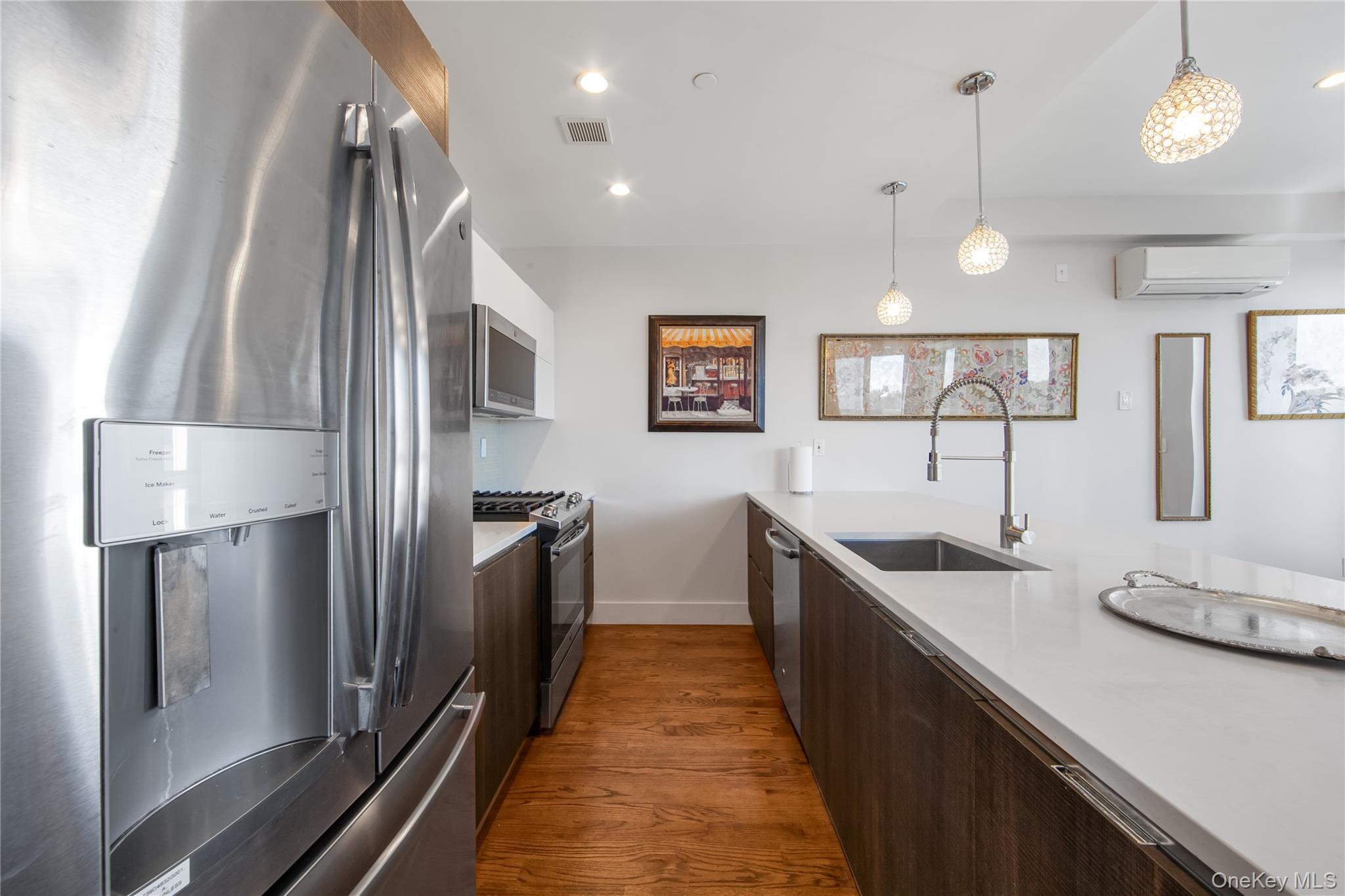 109-19 72nd Road, Unit 7B Queens, NY 11375 - Photo 7 of 17 a kitchen with stainless steel appliances granite countertop a refrigerator a sink and a stove