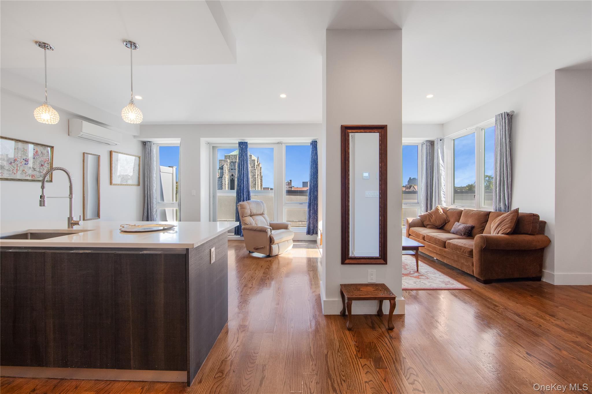 109-19 72nd Road, Unit 7B Queens, NY 11375 - Photo 8 of 17 a living room with furniture and a wooden floor