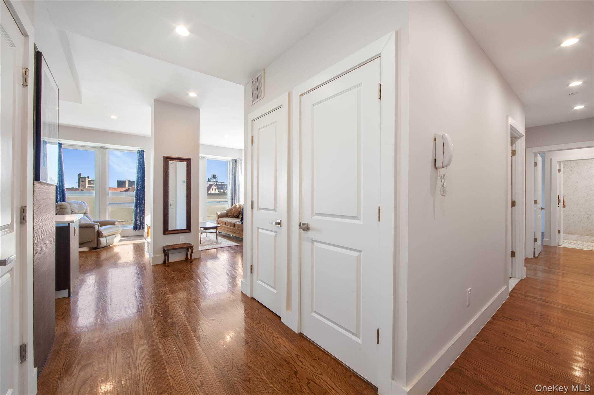 109-19 72nd Road, Unit 7B Queens, NY 11375 - Photo 9 of 17 a view of a hallway with wooden floor windows and livingroom view