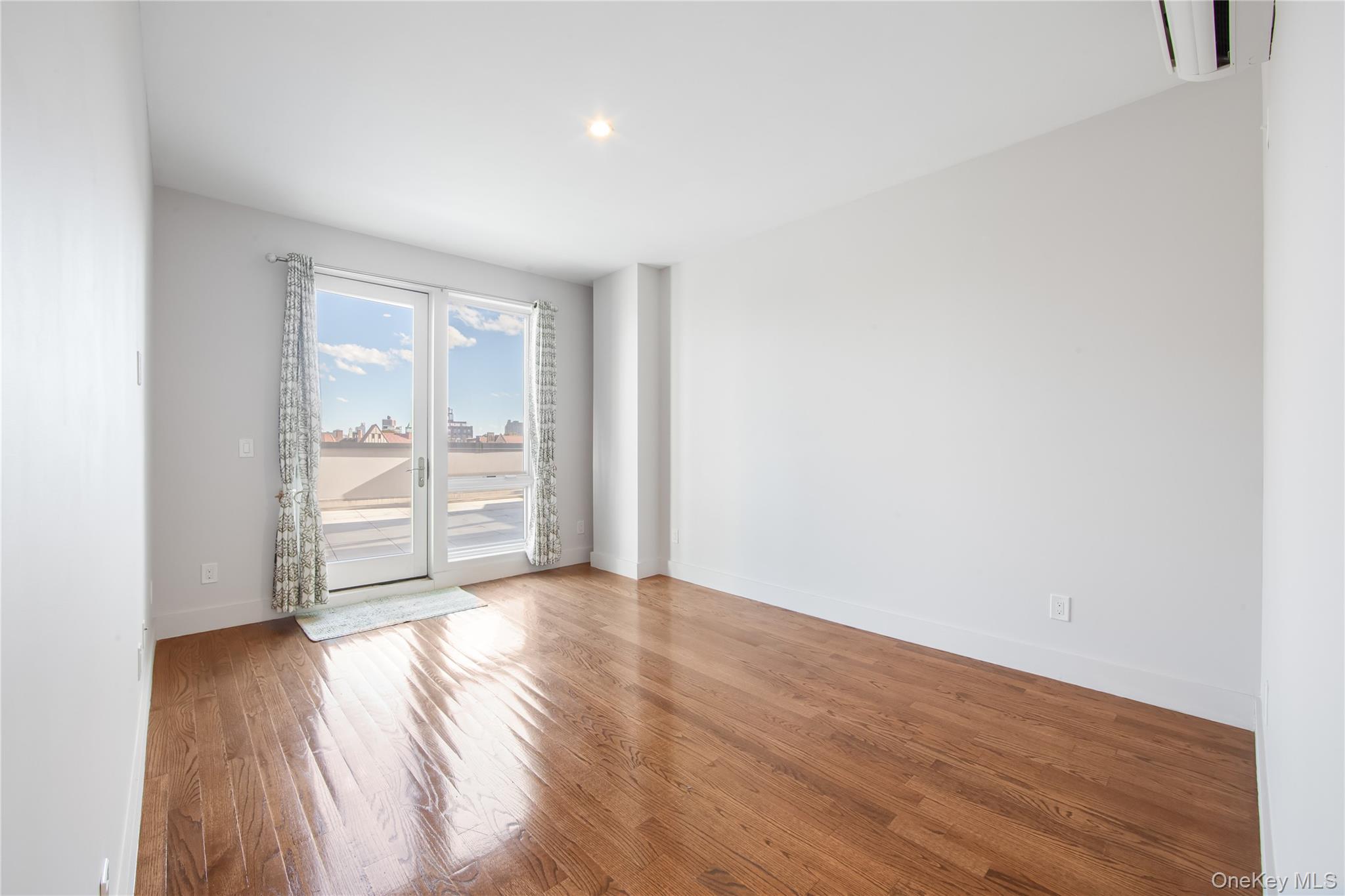 109-19 72nd Road, Unit 7B Queens, NY 11375 - Photo 10 of 17 a view of empty room with wooden floor