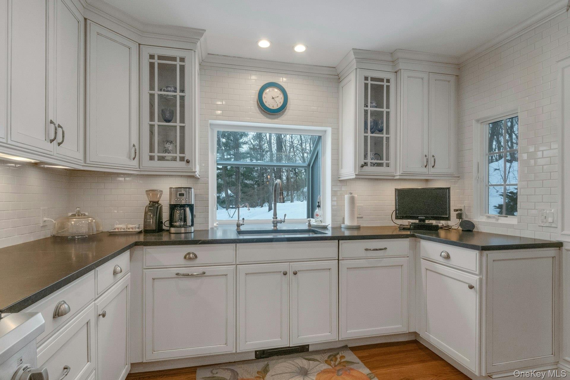 62 Whitson Road Briarcliff Manor, NY 10510 - Photo 14 of 46 Honed Jet Mist Granite counters, glass door cabinets and white custom cabinetry with a large greenhouse window help make this a dream Kitchen.