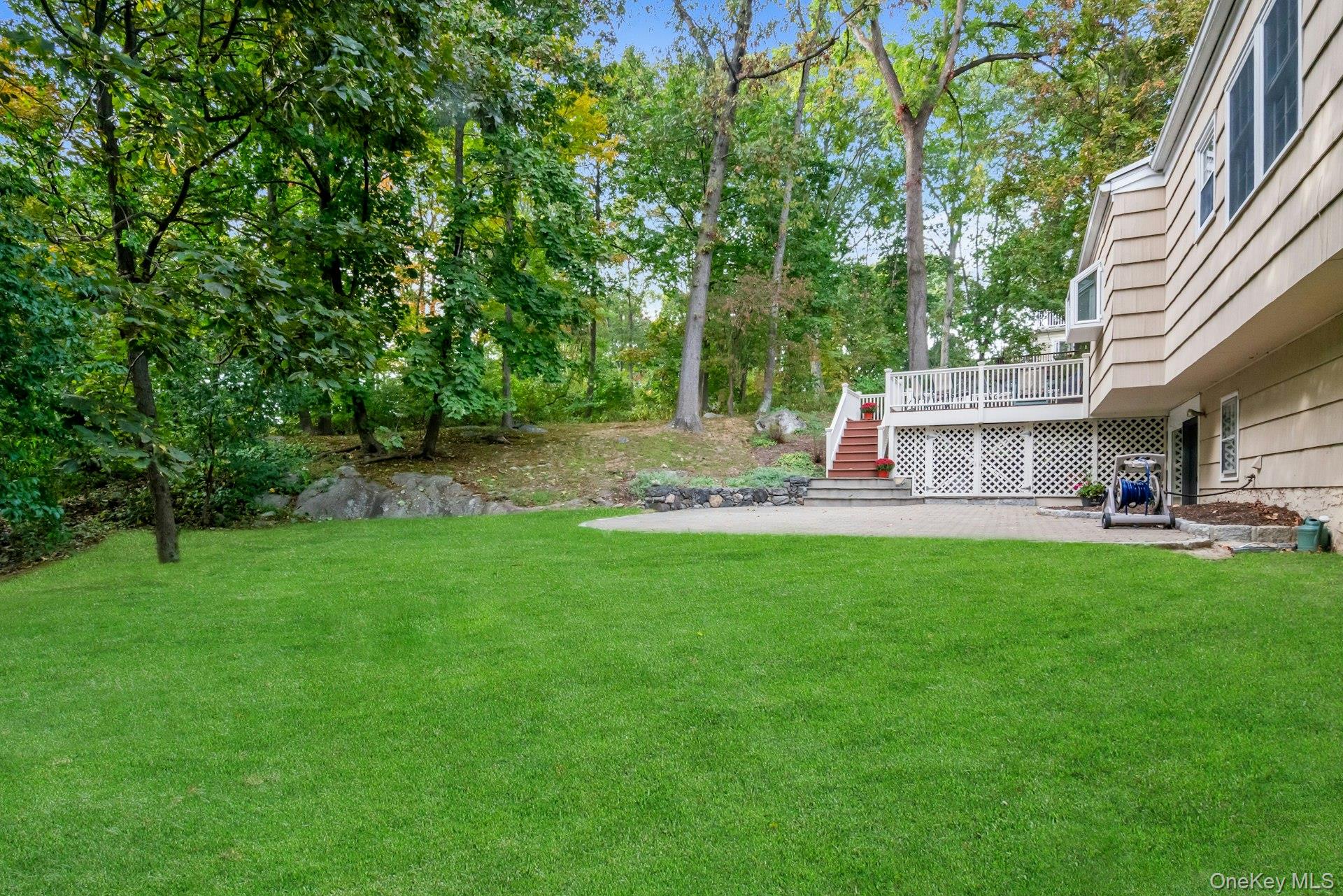 62 Whitson Road Briarcliff Manor, NY 10510 - Photo 37 of 46 While the tree line provides privacy, the large level lawn area in the rear of this 1/2 acre lot leaves room for adventure.