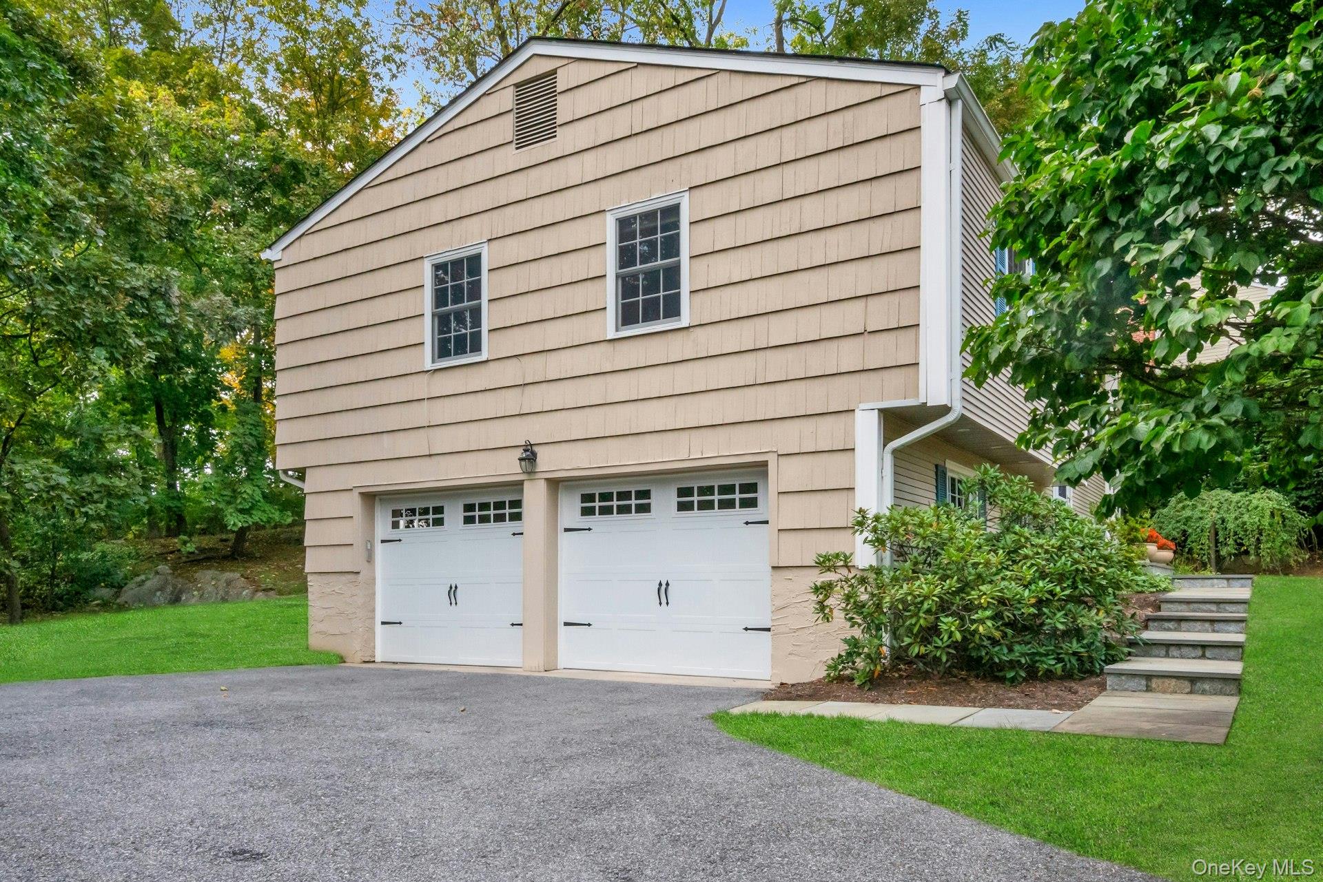 62 Whitson Road Briarcliff Manor, NY 10510 - Photo 39 of 46 Side view of home with 2 car Garage (young automatic garage doors) plus the stone walkway to the front entrance.