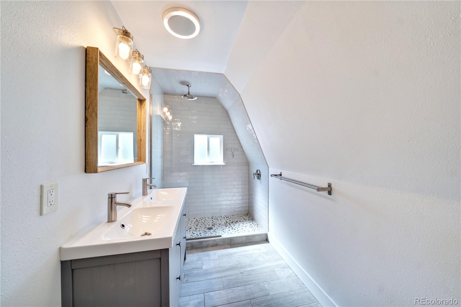 2528 West 23rd Avenue Denver, CO 80211 - Photo 12 of 21 a bathroom with a sink and mirror