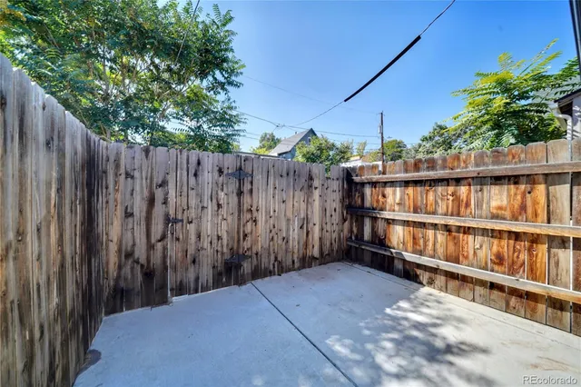 a view of a backyard with wooden fence