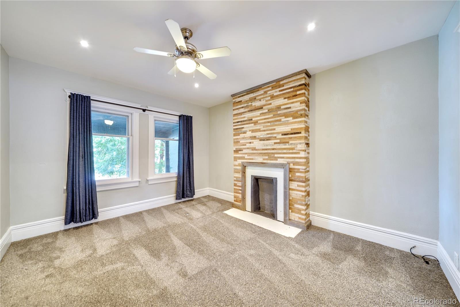 2528 West 23rd Avenue Denver, CO 80211 - Photo 5 of 21 a view of an empty room with window and fire place