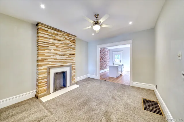 wooden floor fireplace and natural light in room