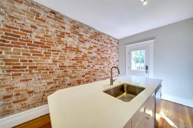 a kitchen with a sink a stove and a window