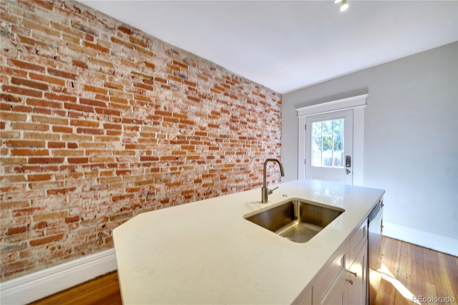 2528 West 23rd Avenue Denver, CO 80211 - Photo 8 of 21 a kitchen with a sink a stove and a window