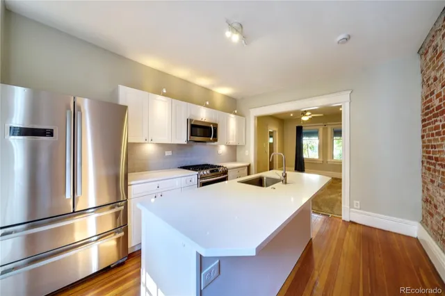 a kitchen with stainless steel appliances a refrigerator and a stove