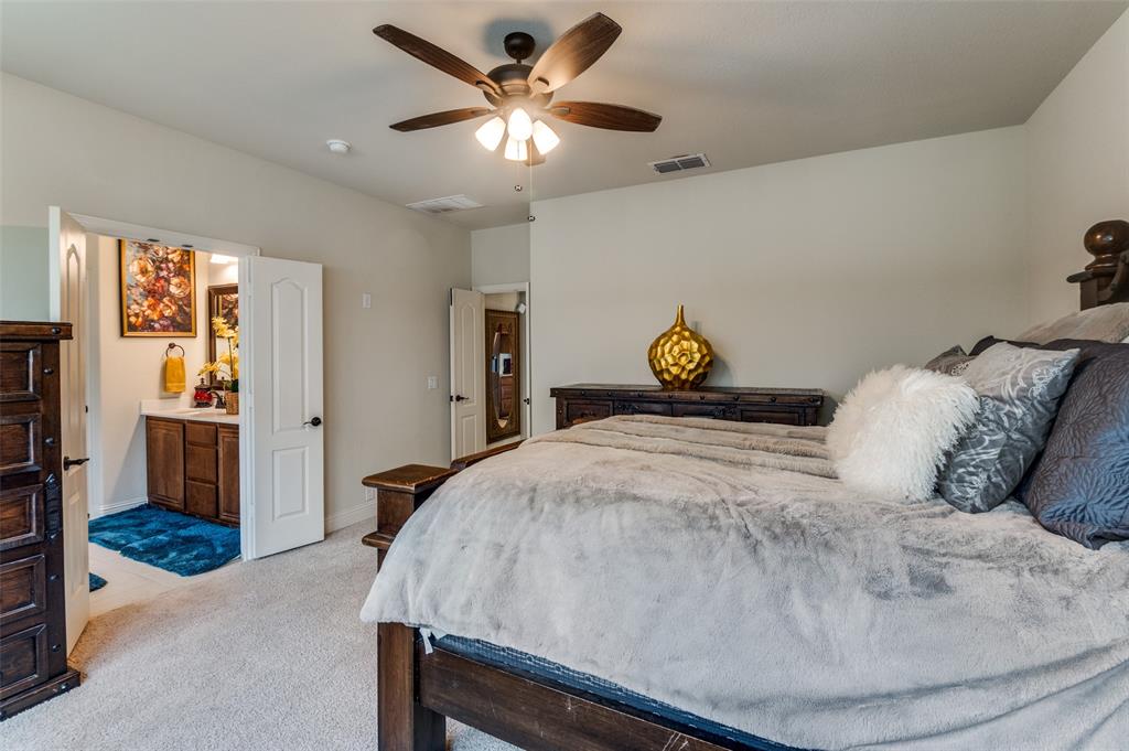 3822 Myrtle Way Kaufman, TX 75142 - Photo 19 of 39 a bedroom with a bed and a chandelier