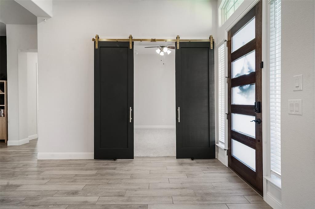 1843 Granite Way Van Alstyne, TX 75495 - Photo 15 of 39 a view of a hallway with wooden floor and entryway