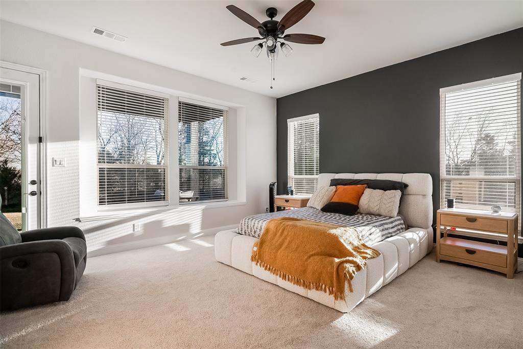 1843 Granite Way Van Alstyne, TX 75495 - Photo 24 of 39 a spacious bedroom with a bed and a couch