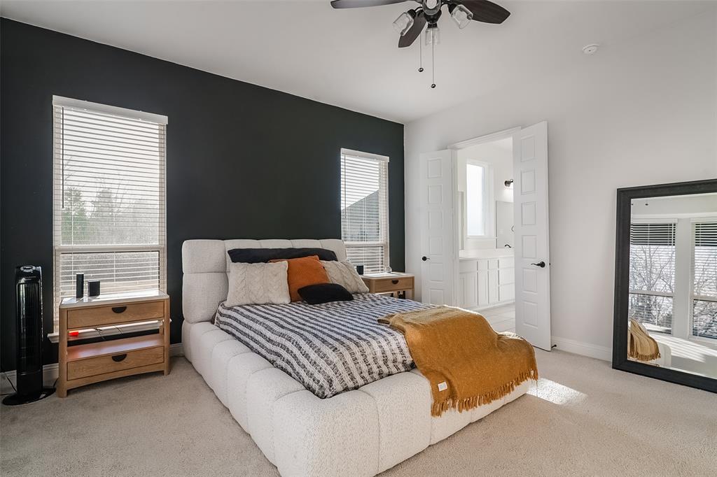 1843 Granite Way Van Alstyne, TX 75495 - Photo 26 of 39 a bedroom with a bed a couch and a chandelier