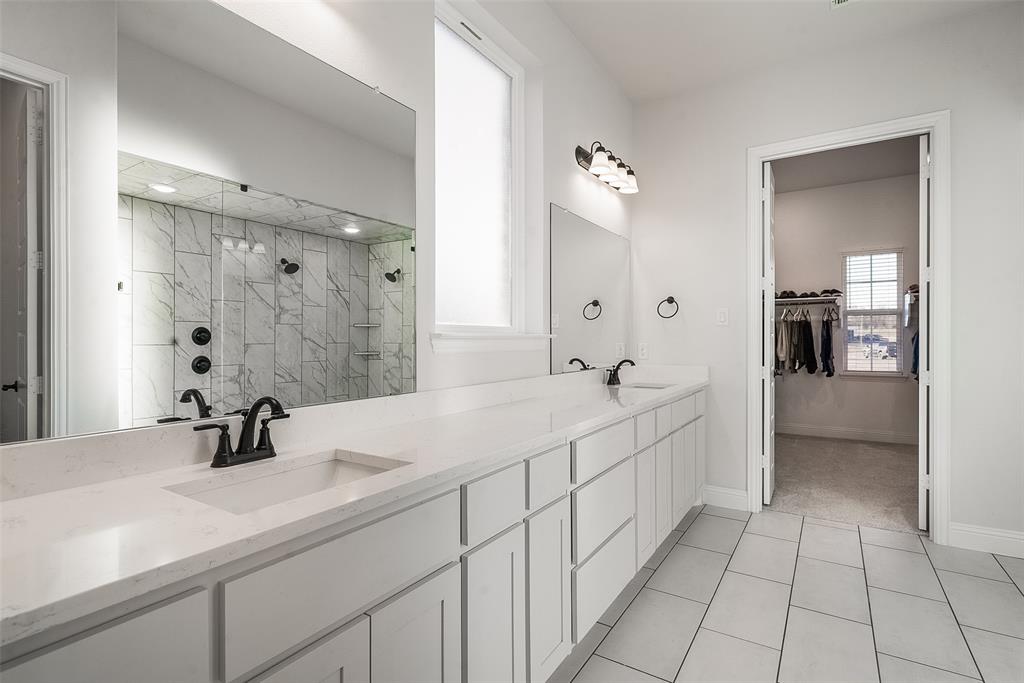 1843 Granite Way Van Alstyne, TX 75495 - Photo 27 of 39 a en suite bathroom with a double sink and mirror