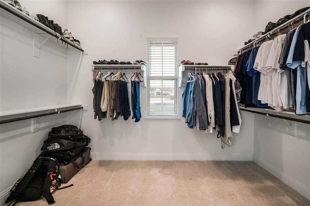 1843 Granite Way Van Alstyne, TX 75495 - Photo 30 of 39 a view of walk in closet with clothes and shoes
