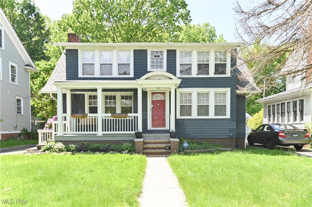 1584 Rydalmount Road Cleveland Heights, OH 44118 - Photo 1 of 36 View of front of property featuring covered porch, a front lawn, and a chimney