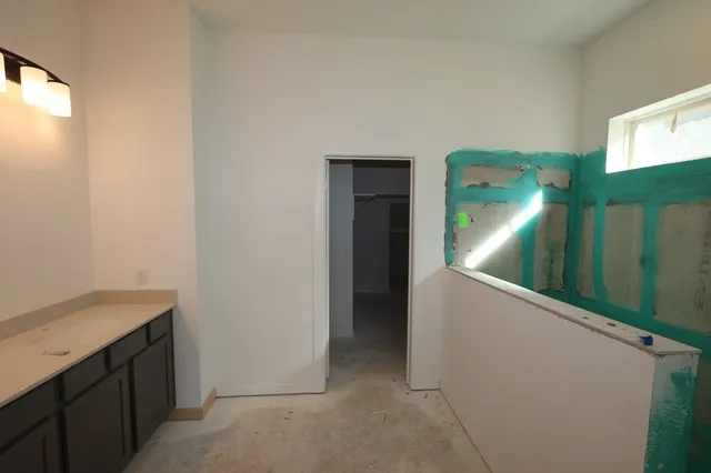 a kitchen with kitchen island a sink stainless steel appliances and cabinets