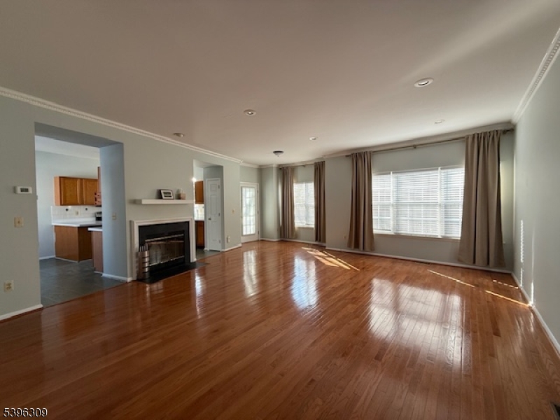 404 Brookview Court Whippany, NJ 07981 - Photo 1 of 29 a view of an empty room with window and wooden floor