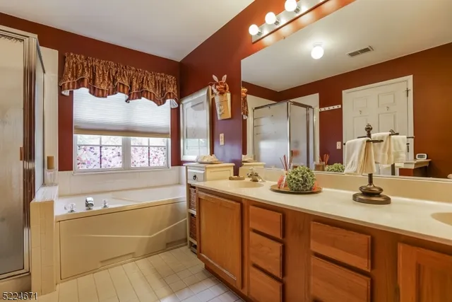 a bathroom with a sink mirror and a bathtub